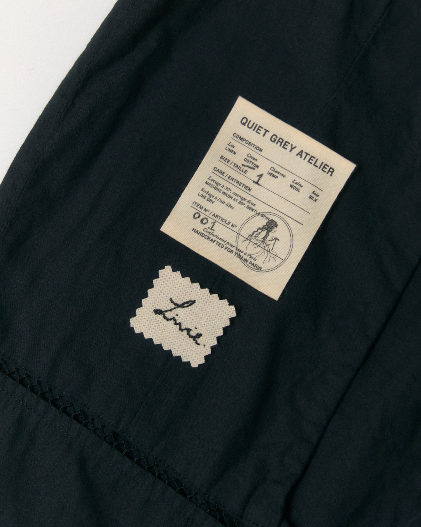 Label and handmade embroidery detail.
