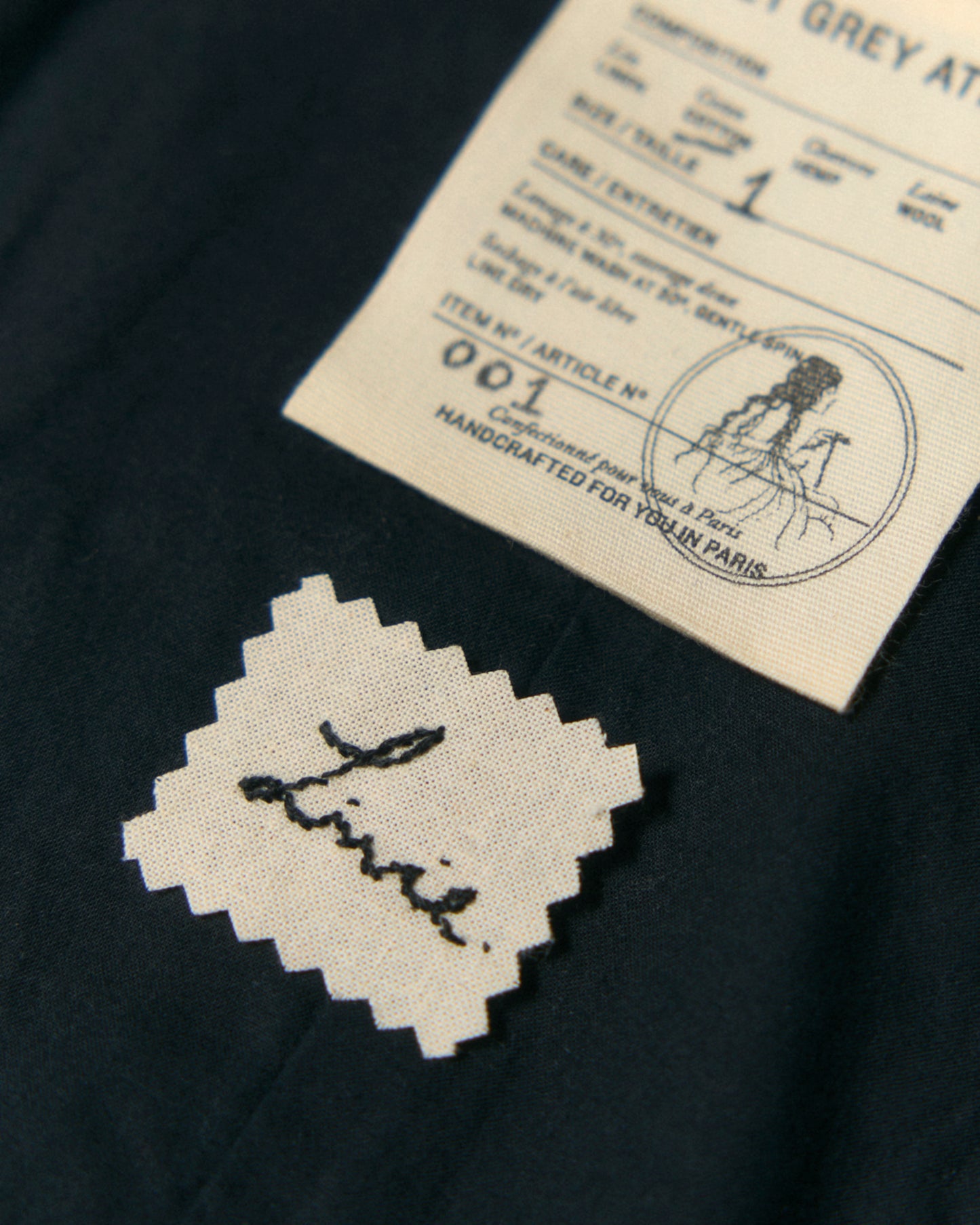 Close-up of hand-embroidered name on the inside of the dress.
