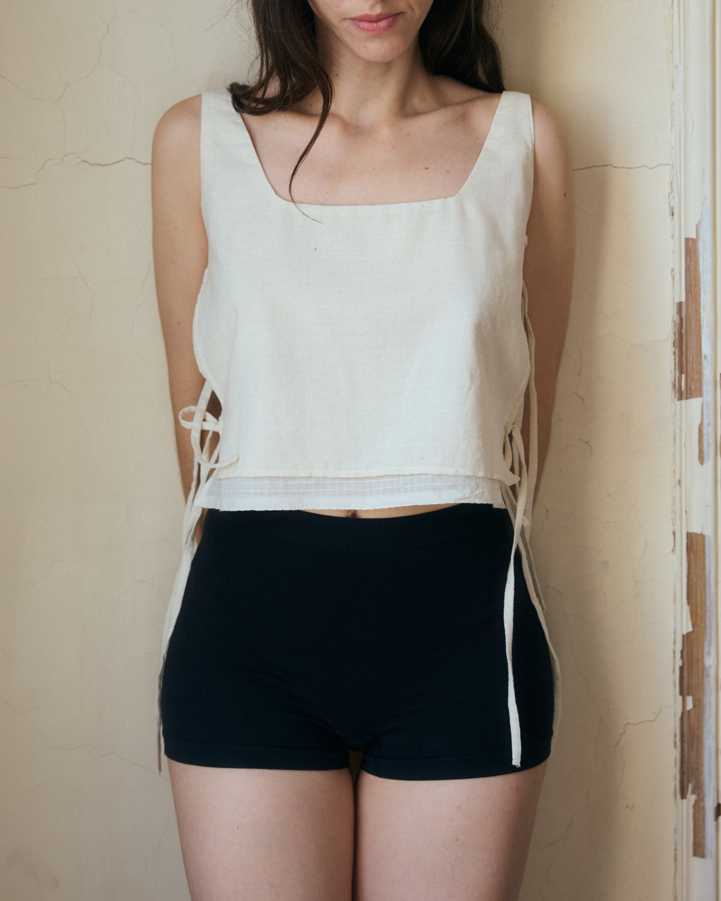 Adjustable top with side ties - front view showing low neckline. Crafted in Paris.