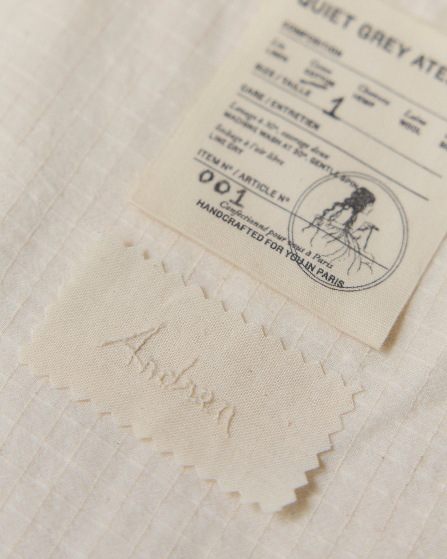 Detail of hand-embroidered name on the inside of the garmenet.