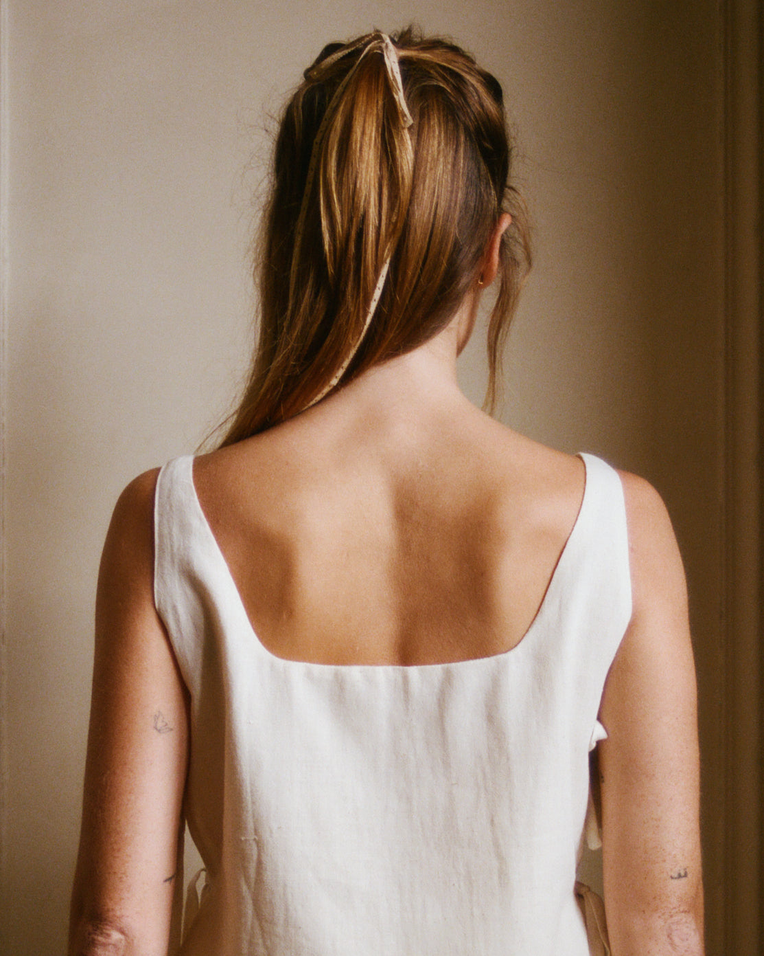 White cotton summer top - back view showing wide and low square neckline.