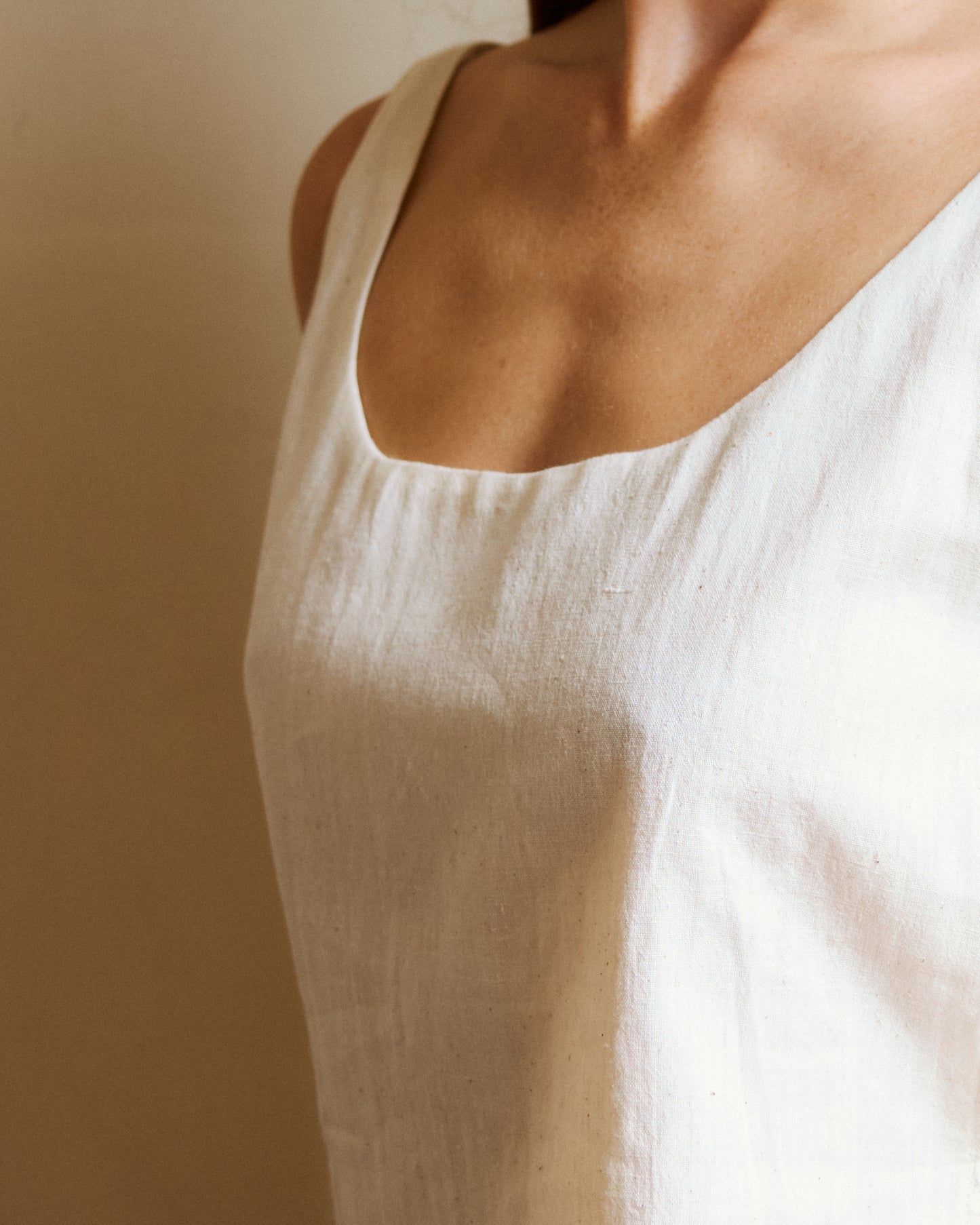 Close-up of round low neckline for white summer top.
