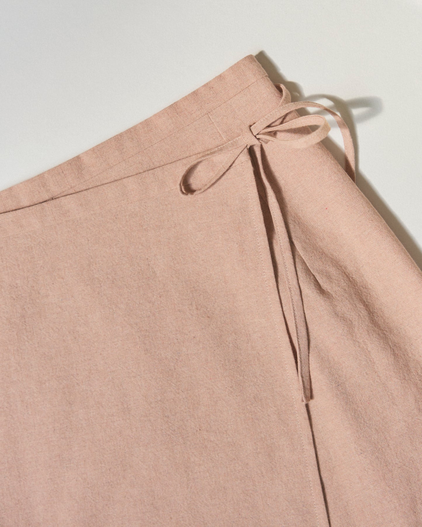 Detail pack shot of wrap skirt closure.