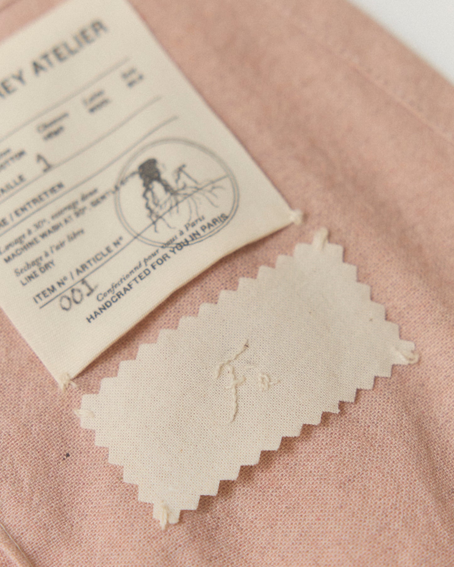 Detail of hand-embroidered name on the inside of our Mini Wrap Skirt.