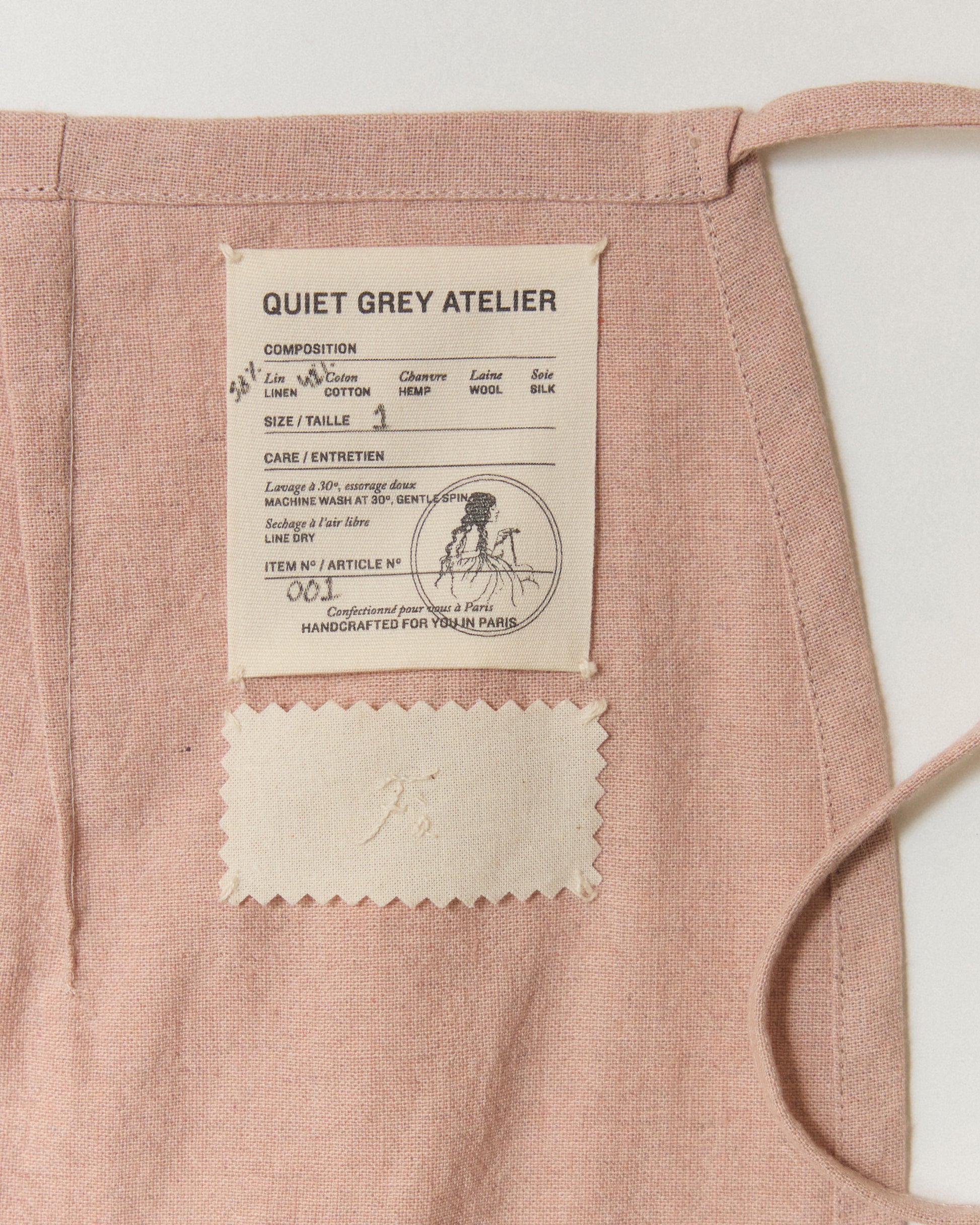 Label and hand-embroidery detail on the inside of Mini Wrap Skirt 01.